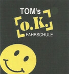 Tom's O.K. Fahrschule Logo